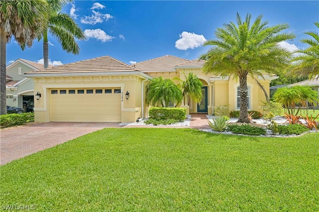 mediterranean / spanish-style home with a garage and a front yard