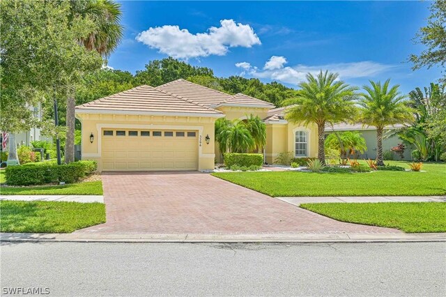 view of front of home featuring a garage and a front lawn