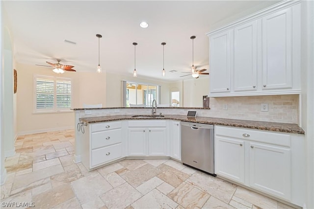 kitchen featuring white cabinetry, pendant lighting, and stainless steel dishwasher