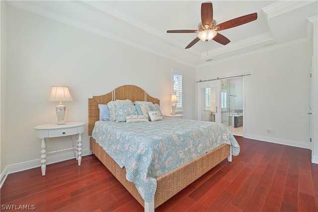 bedroom with ceiling fan, a raised ceiling, crown molding, a barn door, and dark wood-type flooring