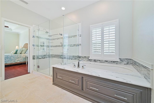 bathroom featuring independent shower and bath and tile patterned flooring