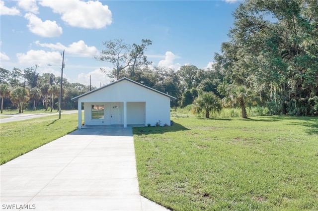 garage with a carport and a lawn