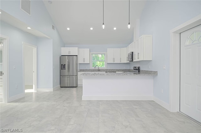 kitchen featuring white cabinetry, hanging light fixtures, light stone countertops, stainless steel appliances, and high vaulted ceiling