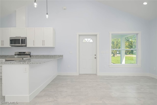 kitchen featuring decorative light fixtures, appliances with stainless steel finishes, light stone counters, and white cabinetry