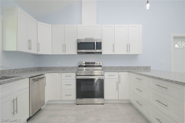 kitchen with light stone countertops, stainless steel appliances, and white cabinetry