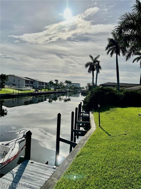 dock area featuring a water view and a yard