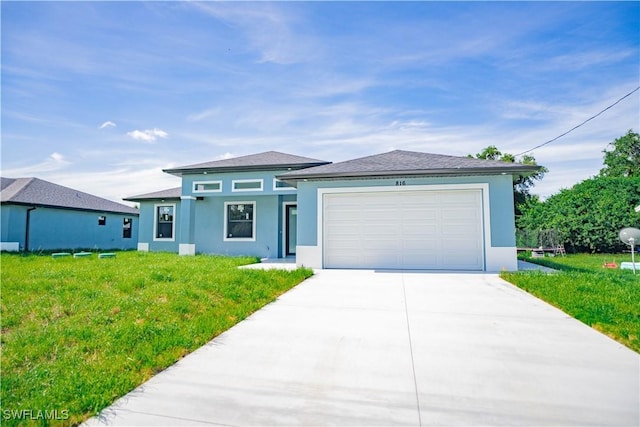 view of front facade featuring a garage and a front lawn