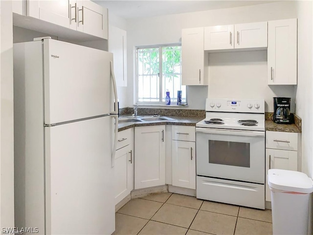 kitchen with sink, white appliances, white cabinets, and light tile patterned flooring