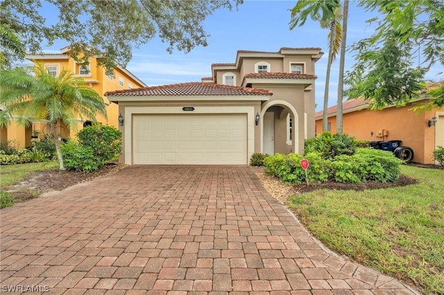 mediterranean / spanish-style home with a garage