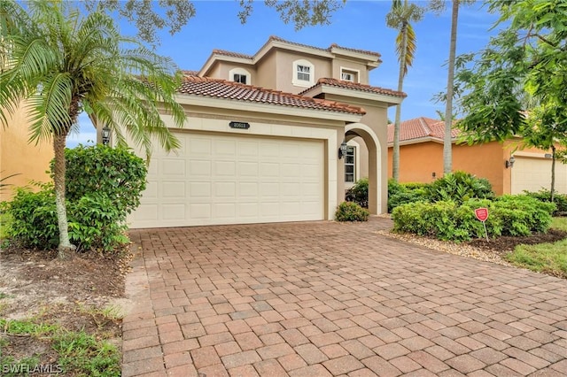 mediterranean / spanish-style house featuring a garage