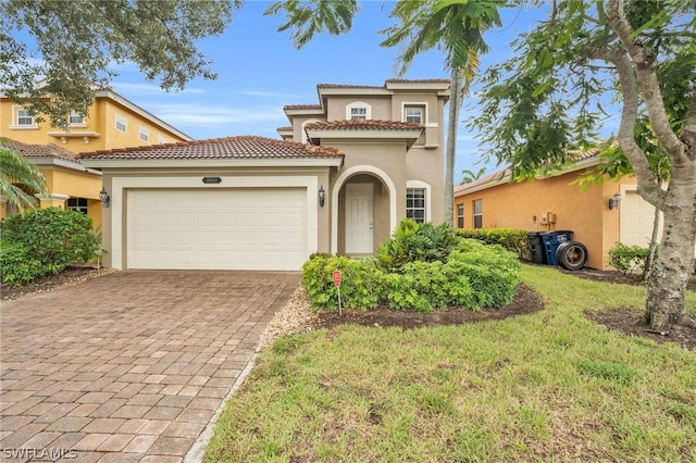 mediterranean / spanish house featuring a garage and a front lawn