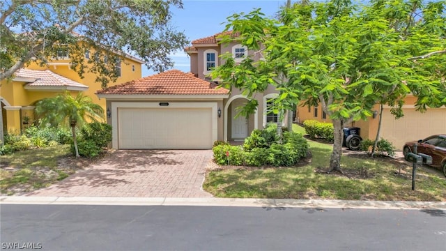 mediterranean / spanish-style house with a garage