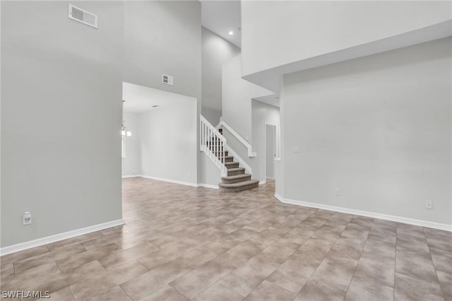 interior space featuring a high ceiling and an inviting chandelier