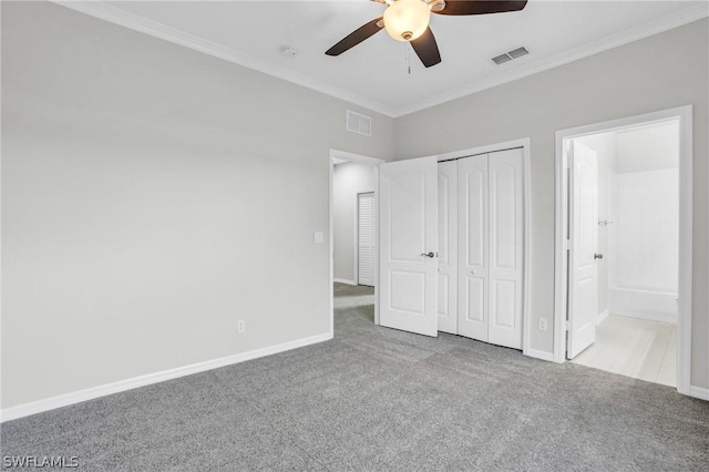 unfurnished bedroom with ensuite bathroom, ceiling fan, crown molding, light carpet, and a closet