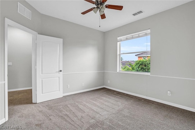 empty room with ceiling fan and light colored carpet