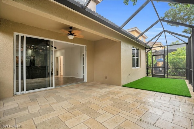 unfurnished sunroom with golf simulator and ceiling fan