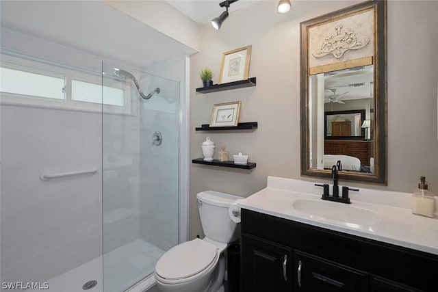 bathroom with vanity, toilet, and a shower with door