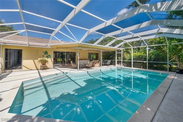 view of swimming pool featuring a lanai and a patio