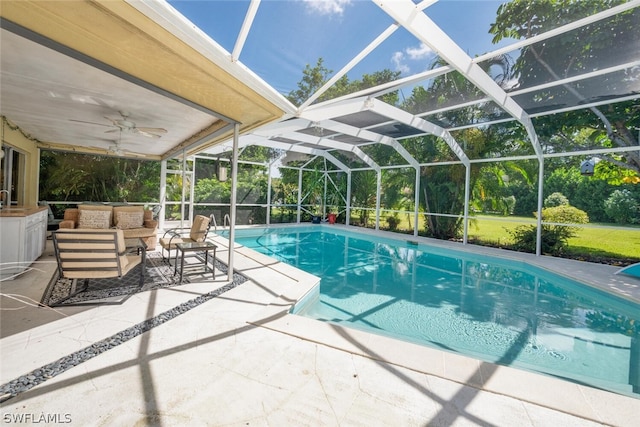 view of swimming pool featuring ceiling fan, an outdoor living space, a lanai, and a patio