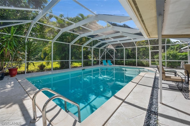 view of pool with a lanai and a patio