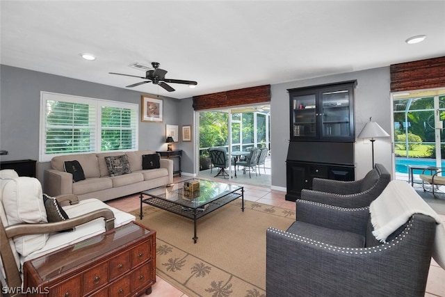 tiled living room featuring ceiling fan