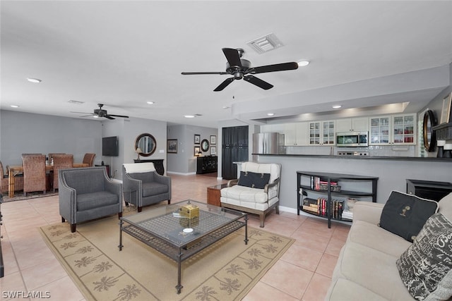 living room featuring light tile patterned flooring and ceiling fan