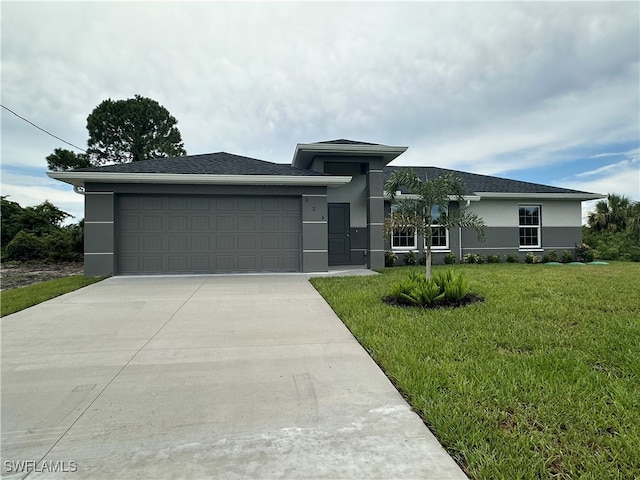 view of front facade featuring a front yard and a garage