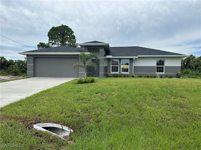 view of front facade featuring a garage, a shingled roof, concrete driveway, stucco siding, and a front yard