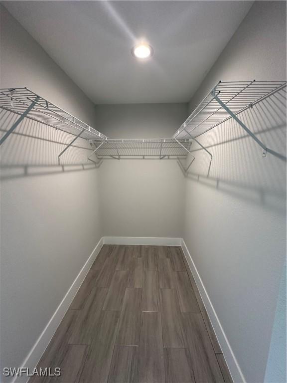 spacious closet with wood finished floors