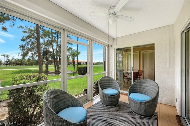 sunroom / solarium featuring ceiling fan