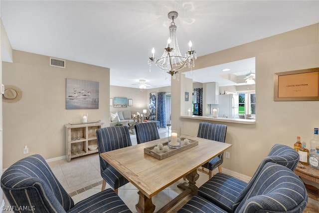 dining area with ceiling fan with notable chandelier and light tile patterned floors