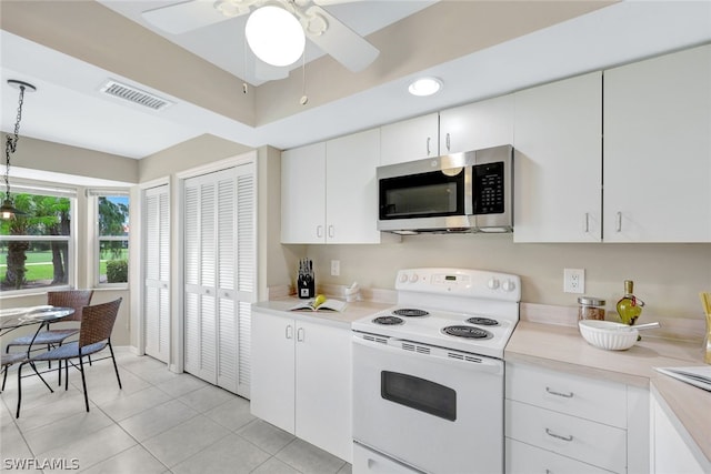 kitchen with light tile patterned flooring, ceiling fan, white electric range, and white cabinets