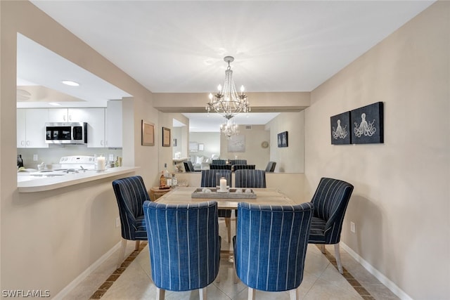 tiled dining room featuring a notable chandelier