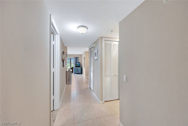 corridor featuring light tile patterned flooring