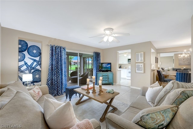 living room featuring ceiling fan with notable chandelier and light tile patterned floors