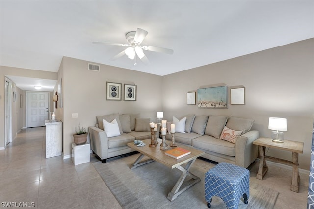 living room with ceiling fan and light tile patterned floors