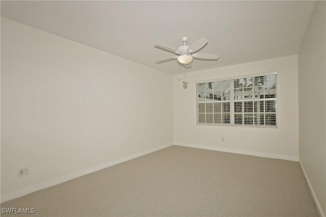 empty room featuring carpet, baseboards, and a ceiling fan