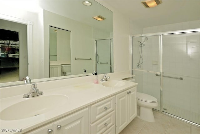 bathroom with toilet, visible vents, a sink, and tile patterned floors