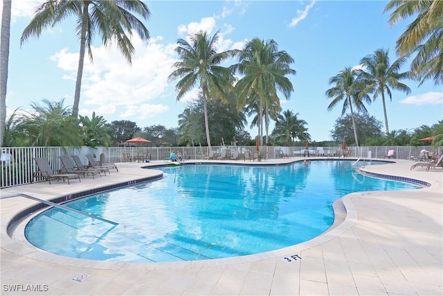 pool featuring fence and a patio