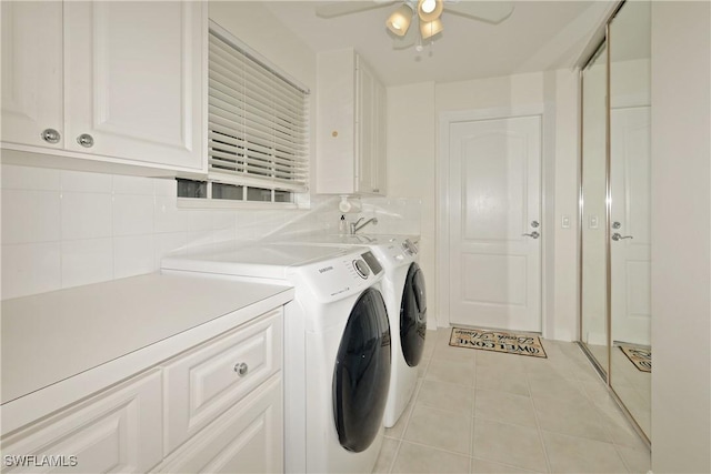 washroom featuring cabinet space, ceiling fan, washer and clothes dryer, and light tile patterned flooring