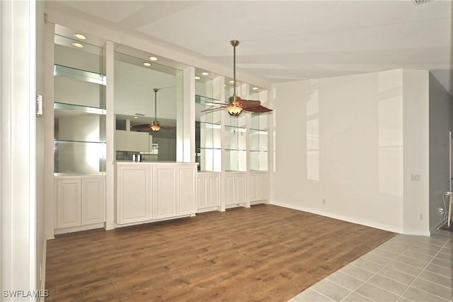 unfurnished dining area with dark wood-type flooring, recessed lighting, and ceiling fan