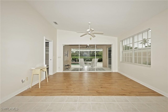 spare room with a ceiling fan, a sunroom, visible vents, and plenty of natural light