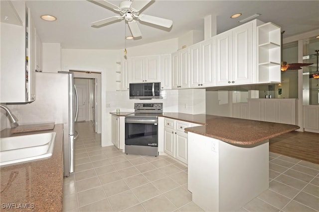 kitchen featuring open shelves, stainless steel appliances, white cabinets, a sink, and a peninsula