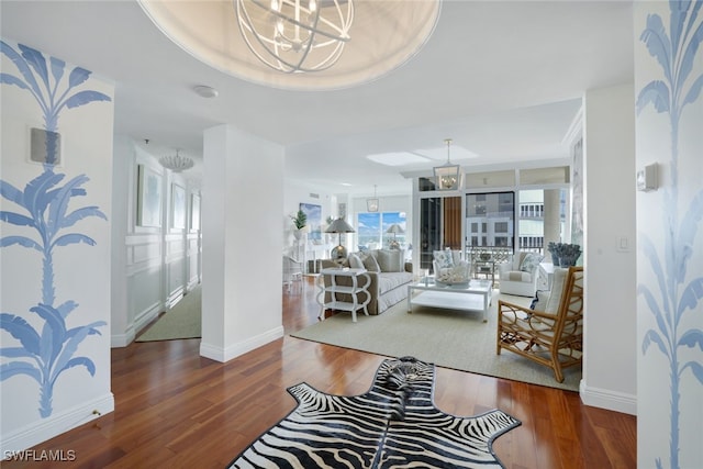 living room featuring hardwood / wood-style flooring and an inviting chandelier