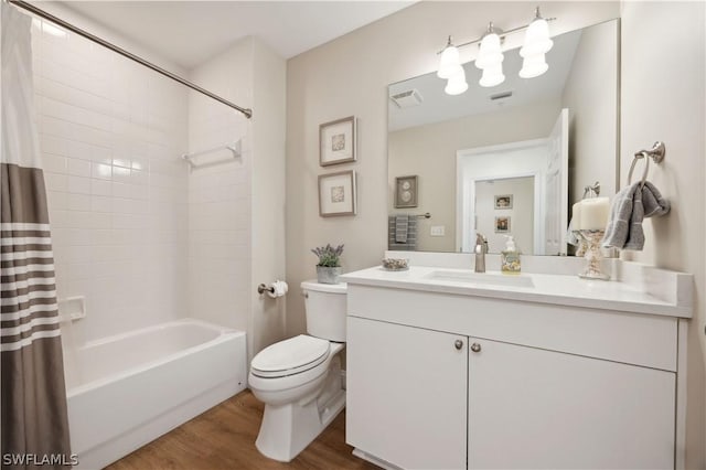 full bathroom with vanity, hardwood / wood-style floors, shower / bathtub combination with curtain, and toilet