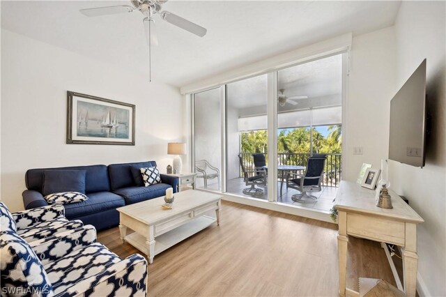 living room featuring ceiling fan and light hardwood / wood-style flooring