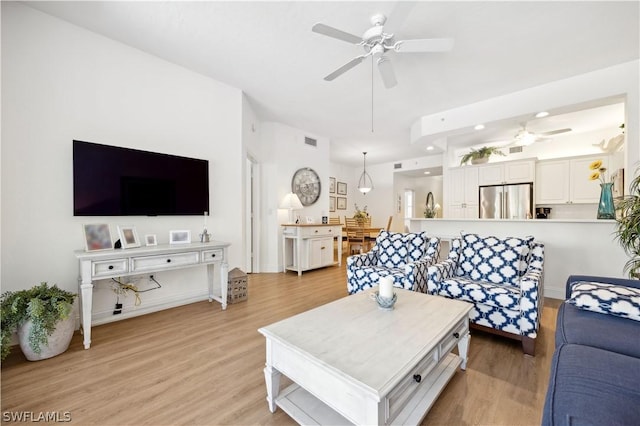 living room featuring light hardwood / wood-style flooring and ceiling fan