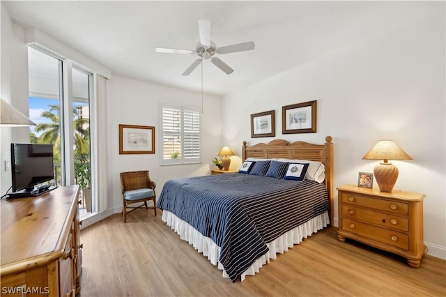 bedroom featuring ceiling fan, access to exterior, and light hardwood / wood-style floors