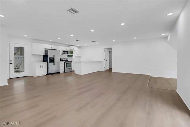 unfurnished living room featuring hardwood / wood-style flooring