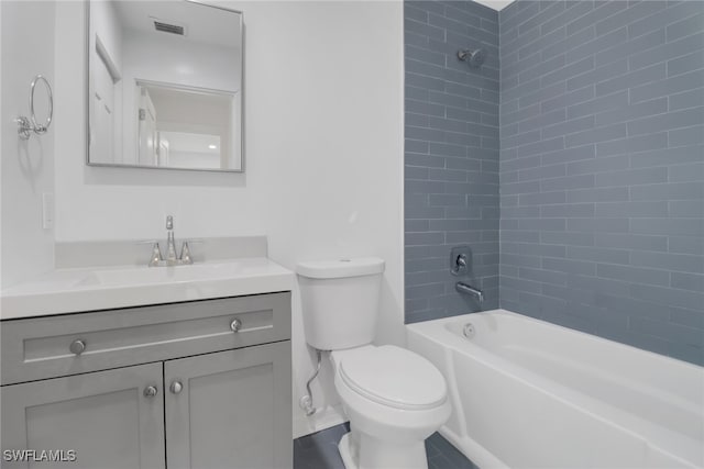 full bathroom with tiled shower / bath combo, vanity, and toilet